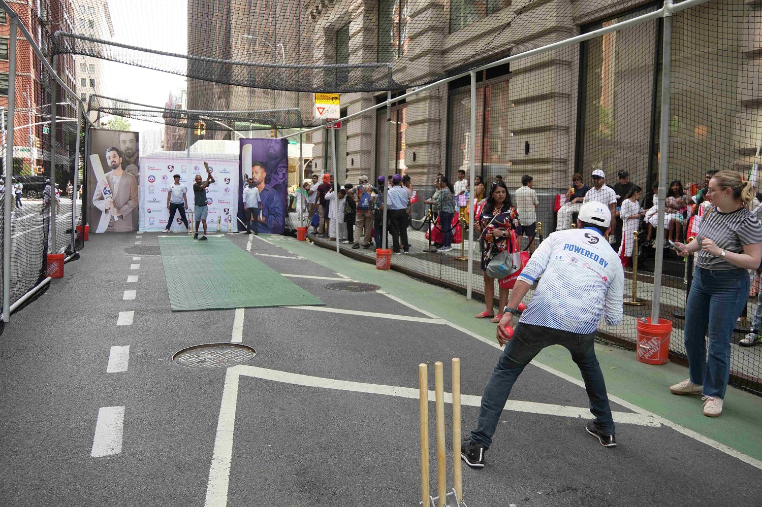 Passersby participated in a game of box cricket on Park Avenue, organized by Cricmax Connect